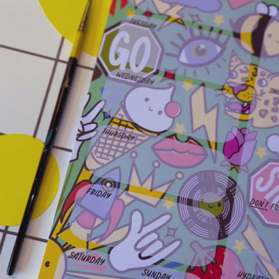 Video of a4 desk planner by the Stoofy store. Fun. Dopamine. Stationary lover. ADHD planner. Illustrated pattern including: suns, leopards, records, hearts, ice cream, crown, peace hand sign, lips, rocket, moon, strawberry, rose, cloud, four leaf clover, stop sign, go sign, eye, bumble bee, lightning, camera, chocolate.